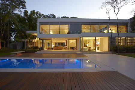 delightful-backyard-inground-swimming-pool-design-with-square-shape-and-wooden-pool-deck-front-of-open-plan-living-room